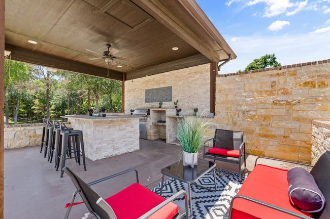 View of patio featuring exterior kitchen and ceiling fan | Image 35