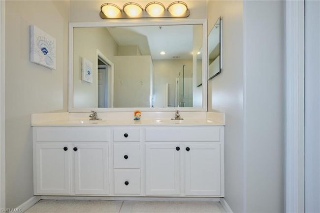 Bathroom featuring a shower with door and vanity | Image 40