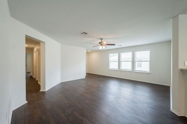 Spare room with ceiling fan, dark wood-style floors, and baseboards | Image 5
