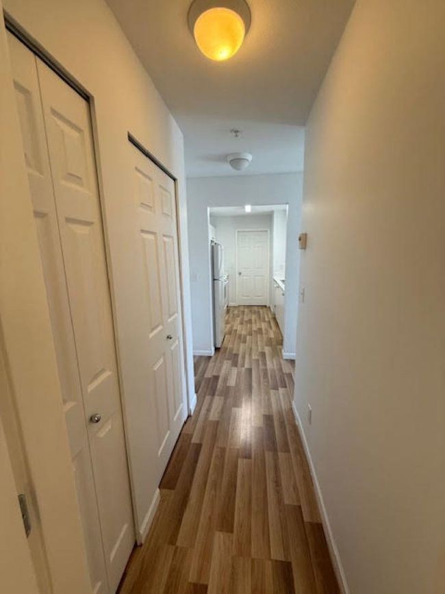 Corridor featuring dark wood-style flooring and baseboards | Image 12