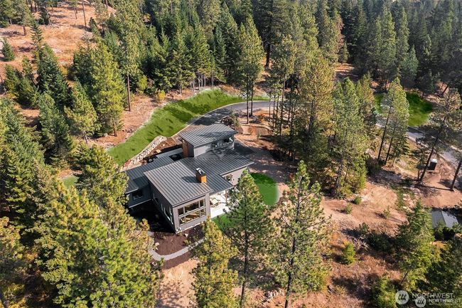 This stunning modern luxury home sits proudly on 5 private, southern-facing view acres secluded in tall timber | Image 39