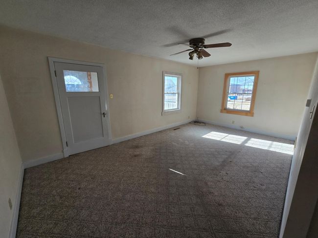 Living room has front door access | Image 12
