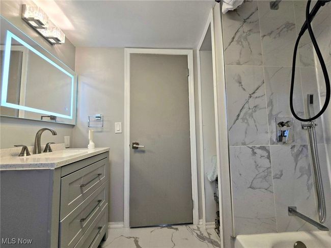 Full bath featuring vanity, marble finish floor, and walk in shower | Image 36