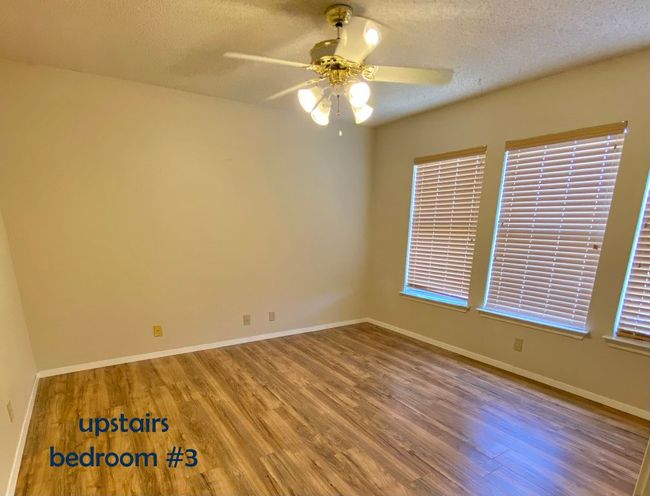 Bedroom with vinyl floors, ceiling fan | Image 16