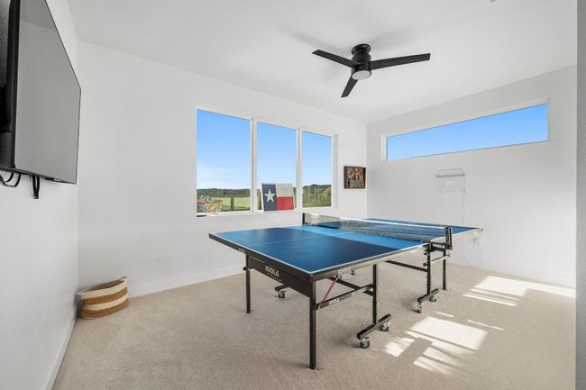 The expansive recreation and game room is designed for endless entertainment and relaxation, providing the perfect space for game nights, billiards, or casual gatherings with family and friends. Featuring premium finishes, ample seating, and an inviting atmosphere, this versatile space ensures fun and enjoyment for all ages. | Image 30