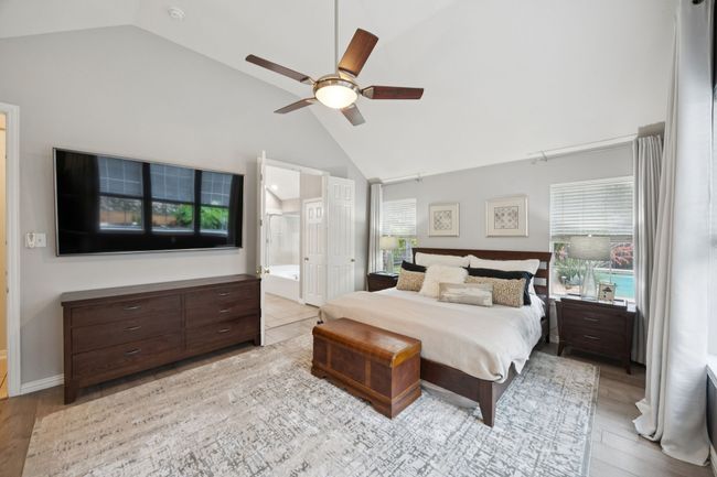 Enjoy the ease of direct access to the en-suite bath from this generously sized bedroom retreat, complete with dual closets and serene backyard views. | Image 17