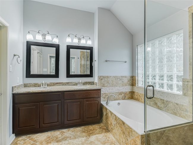 Dual sink granite vanity and porcelain tile flooring. | Image 17