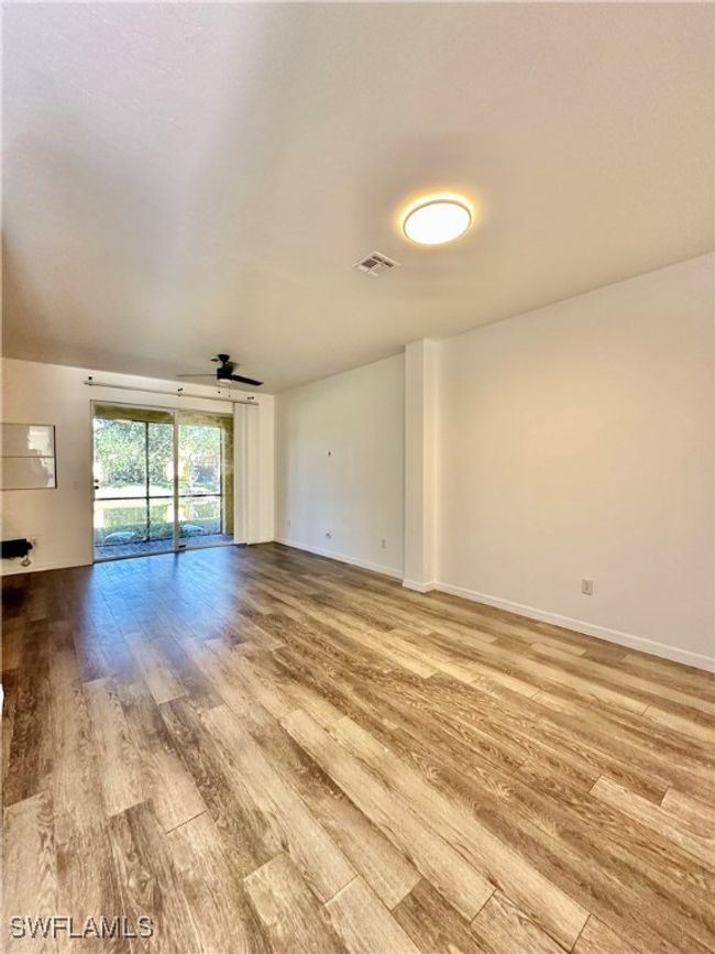 Spare room with ceiling fan and light wood-type flooring | Image 7