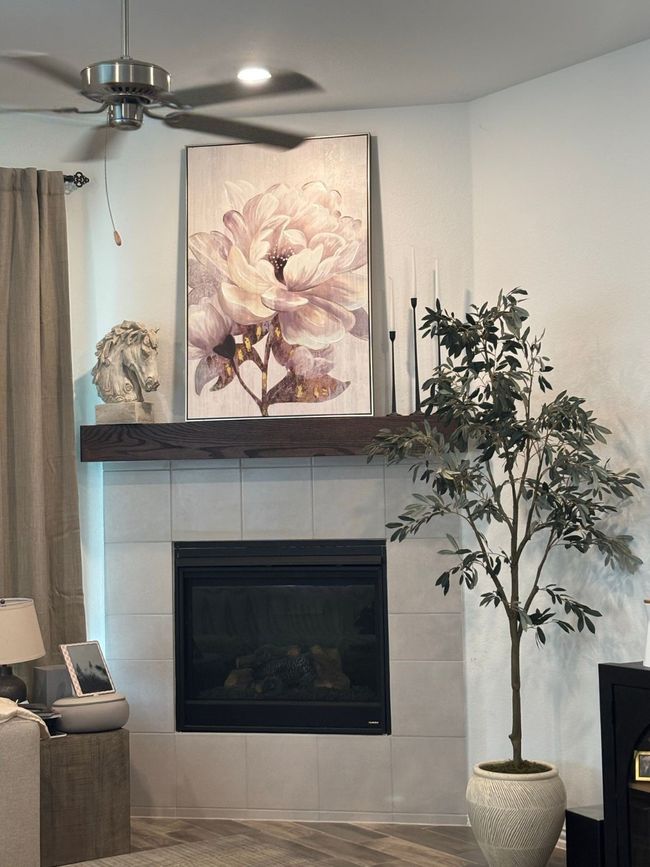 Detailed view of a fireplace, wood finished floors, and a ceiling fan | Image 6