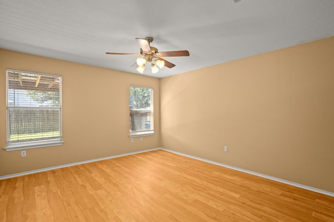 Spare room featuring plenty of natural light, light wood-style floors, and ceiling fan | Image 11