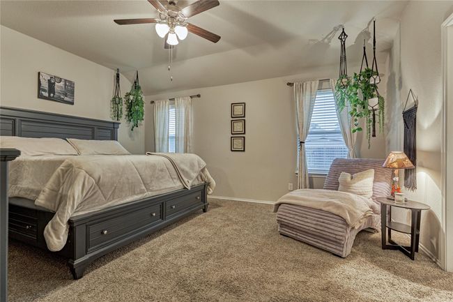 Spacious primary bedroom with room for a sitting area and has views of the back yard. | Image 27