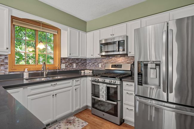 The breakfast bar provides added seating or a great buffet for serving guests. | Image 14