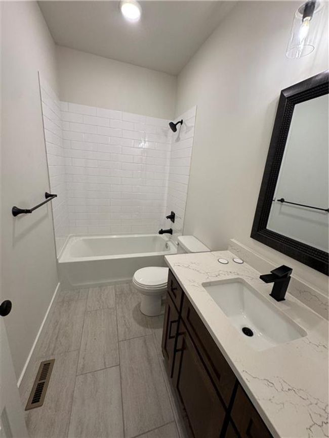 Bathroom featuring vanity and shower / washtub combination | Image 51