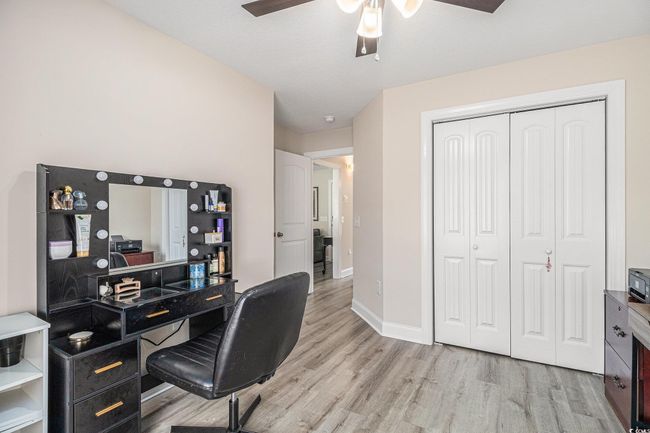 Office area featuring a ceiling fan, light wood-style flooring, and baseboards | Image 12