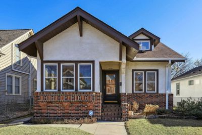 Stucco and brick exterior of home with new roof... | Image 1