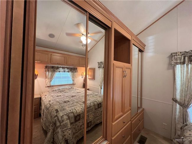 Carpeted bedroom featuring lofted ceiling, crown molding, and ceiling fan | Image 9
