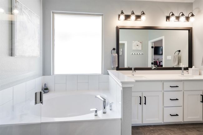 Full bathroom featuring double vanity, a garden tub, connected bathroom, and a sink | Image 26