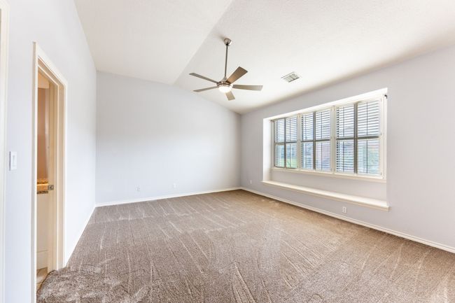 Carpeted spare room with a ceiling fan and vaulted ceiling | Image 14