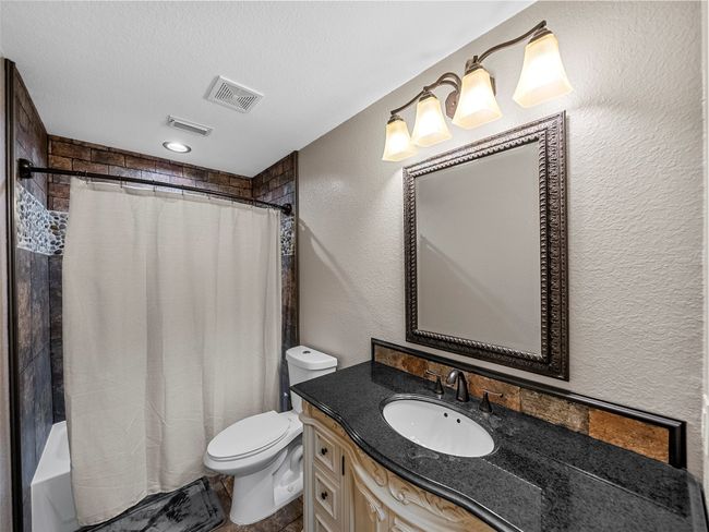 Full bath with a textured wall, visible vents, toilet, and vanity | Image 29