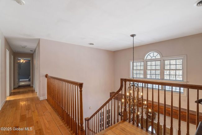 2nd floor hallway leading to a bedroom on the right, bedroom at end of hall, full bathroom on left, laundry room on left and linen closet on left | Image 21
