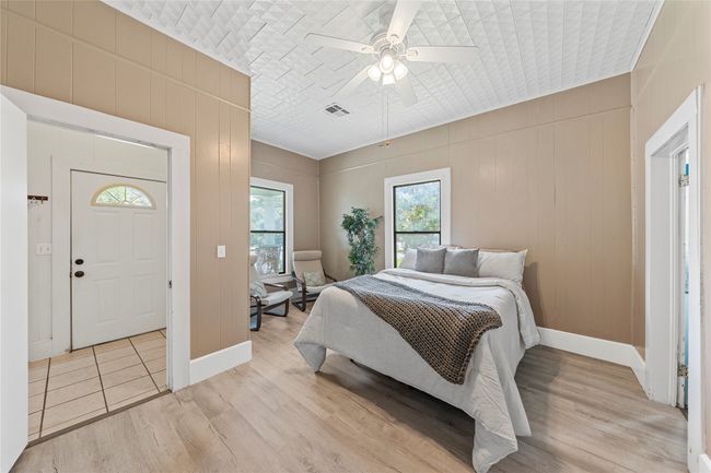 Bedroom with light wood finished floors and a ceiling fan | Image 10