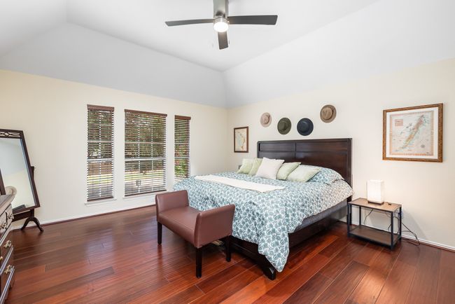 Bedroom featuring lofted ceiling, hardwood / wood-style floors, and a ceiling fan | Image 24