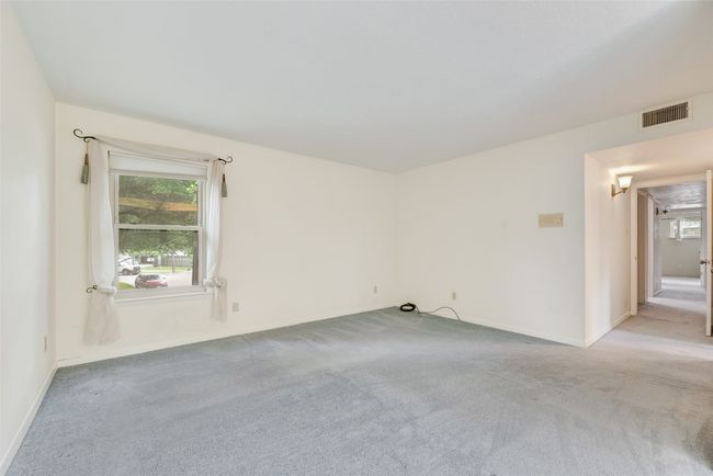 Empty room featuring light carpet and baseboards | Image 28