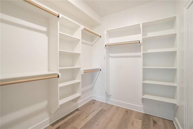 Walk in closet featuring wood finished floors | Image 51