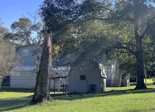 View of home and storage from side yard. | Image 8