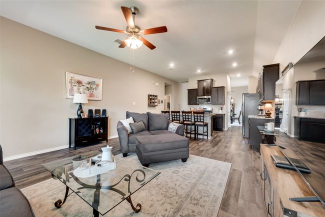Living room with ceiling fan, wood finished floors, and recessed lighting | Image 18