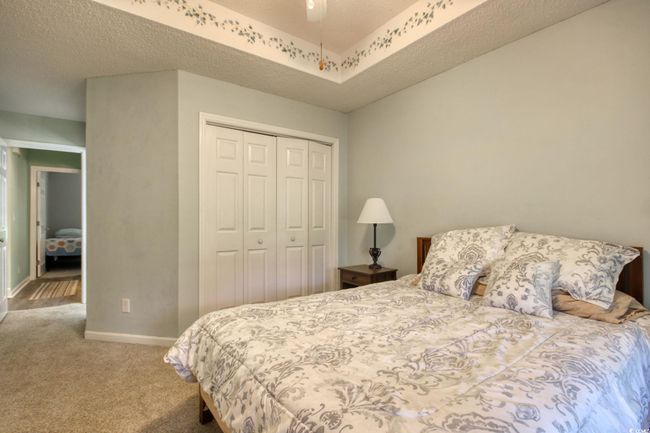 Carpeted bedroom with a closet and baseboards | Image 22