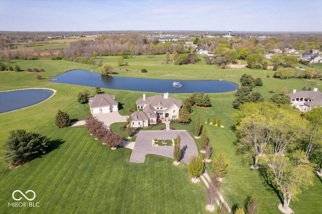 Ariel view of the sprawling 6.2 acre estate. This home has a private, gated entry and a stately driveway framed by a beautiful treeline. | Image 49