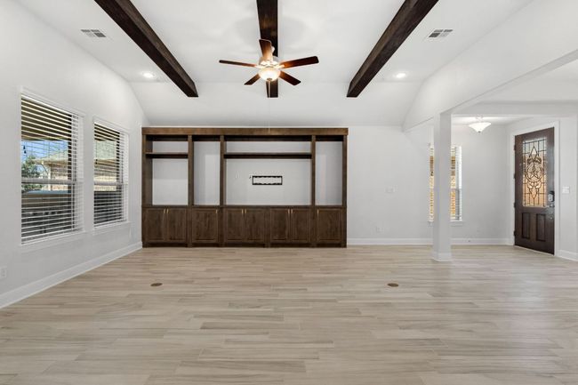 Entrance foyer featuring light wood-type flooring, visible vents, and vaulted ceiling with beams | Image 7