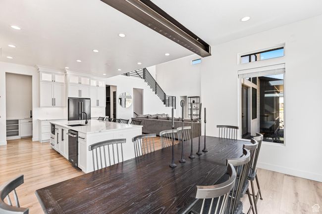 Dining space with beamed ceiling, stairway, recessed lighting, light wood finished floors, and baseboards | Image 59