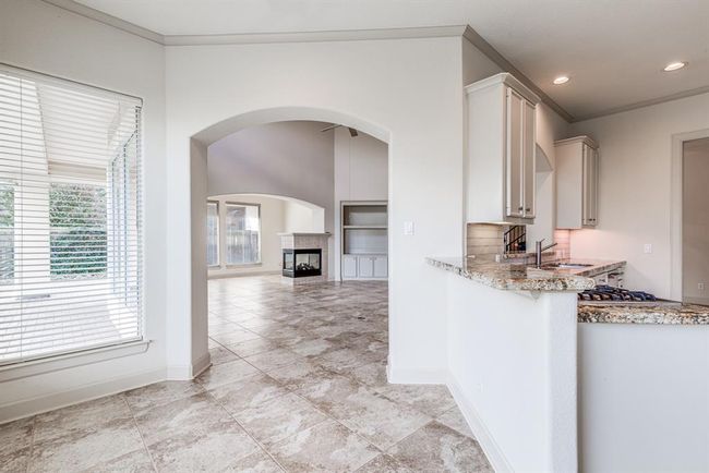 This kitchen boasts two breakfast bar areas, great for entertaining. Open to living space and easy access to back patio area for grilling out or enjoying a morning coffee. | Image 20