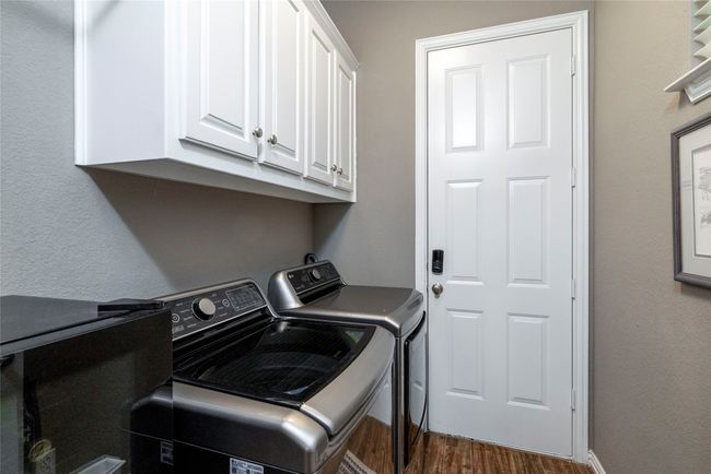 Laundry area featuring separate washer and dryer area and built in cabinets. | Image 12