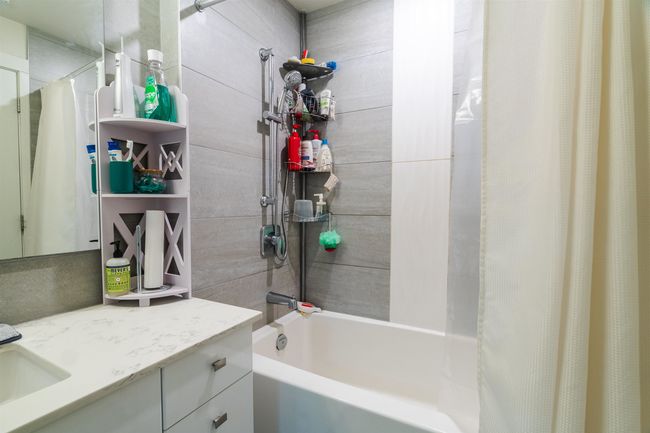 Bathroom with shower / bath combo with shower curtain and vanity | Image 13