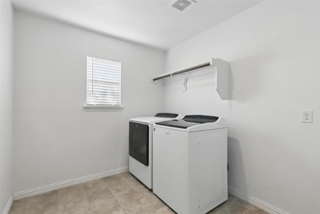 Laundry room featuring washing machine and clothes dryer and baseboards | Image 19