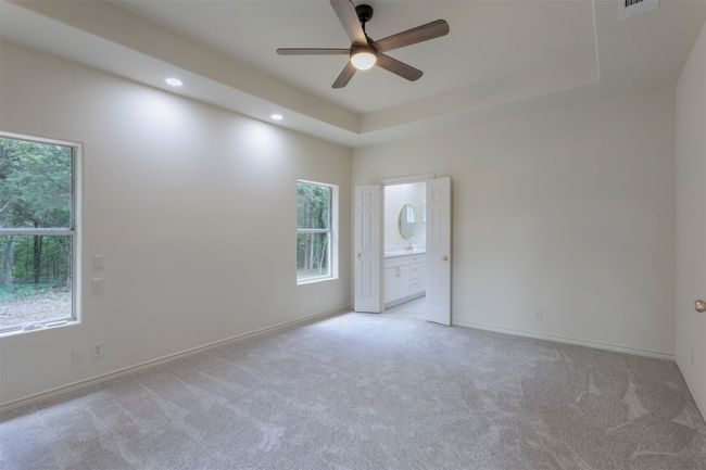 Spare room featuring ceiling fan, light carpet, recessed lighting, baseboards, and a raised ceiling | Image 17