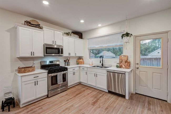 The kitchen is as functional as it is inviting, featuring ample cabinetry, modern appliances, and a layout that makes every day cooking a joy. | Image 12