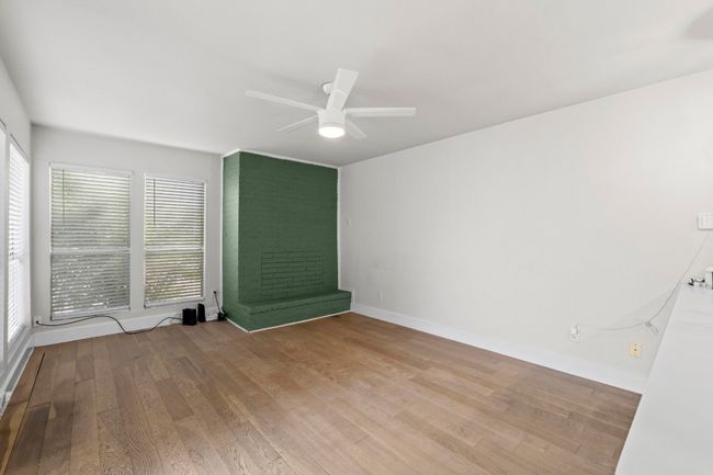 Spare room featuring a ceiling fan, wood finished floors, and baseboards | Image 29