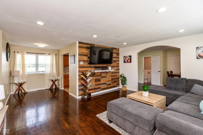 living room featuring arched walkways, wood finished floors, and recessed lighting | Image 6