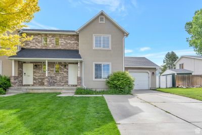 View of front property featuring a front lawn and a garage | Image 1