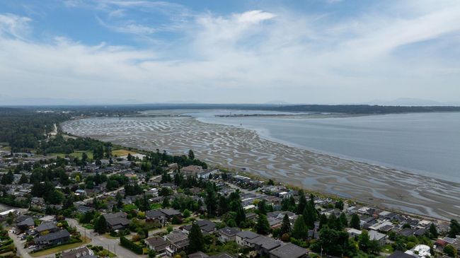 Aerial view of property and surrounding area with a large body of water and nearby suburban area | Image 31