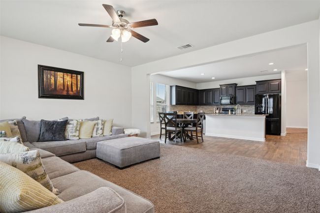 Living room featuring ceiling fan, light wood finished floors, baseboards, and recessed lighting | Image 4