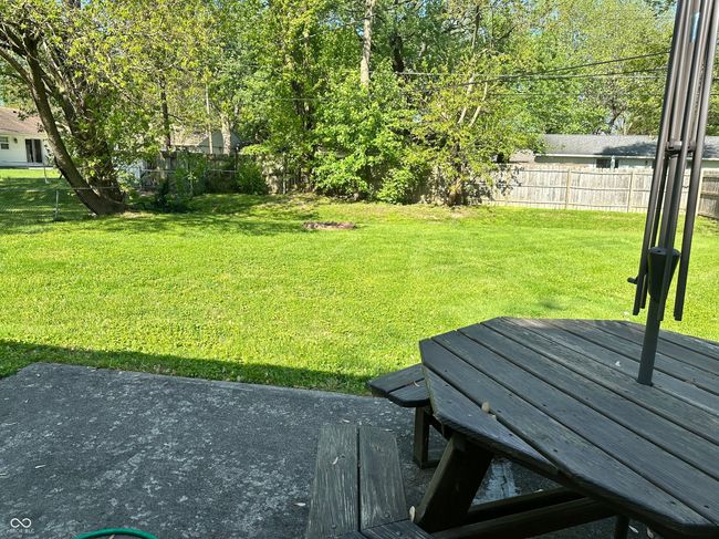 fenced backyard with a wooden deck | Image 15