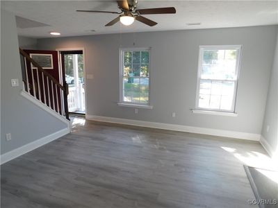 Living room with ceiling fan, and a wealth of natural light | Image 3