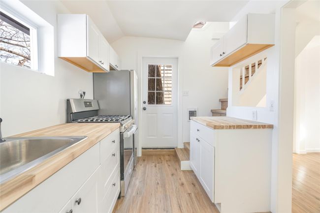 Kitchen featuring light wood-style flooring, gas stove, and butcher block counters | Image 8