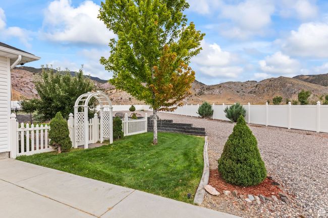 Fenced backyard featuring a mountain view | Image 100