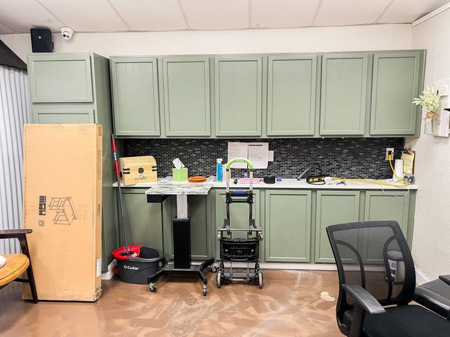 Kitchen with green cabinets, light countertops, tasteful backsplash, and a drop ceiling | Image 10